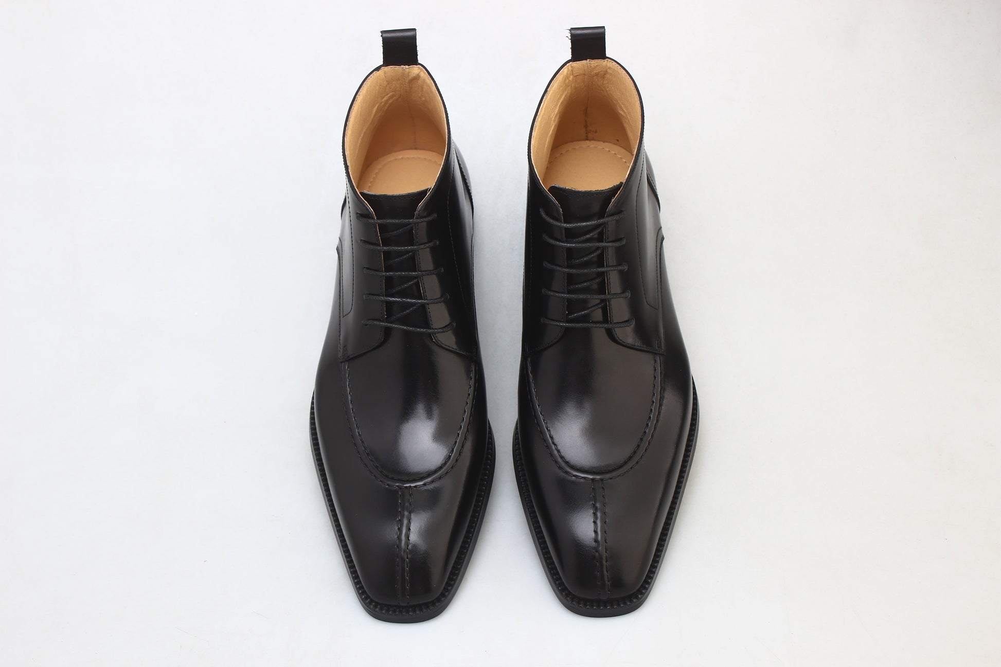 Midnight Noir Lace-Up Boots in sleek black leather, designed for formal occasions and business wear.