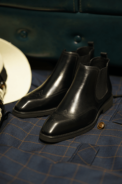 Men's Black Brogue Leather Boots with polished leather and intricate brogue detailing, featuring elastic side panels for comfort.