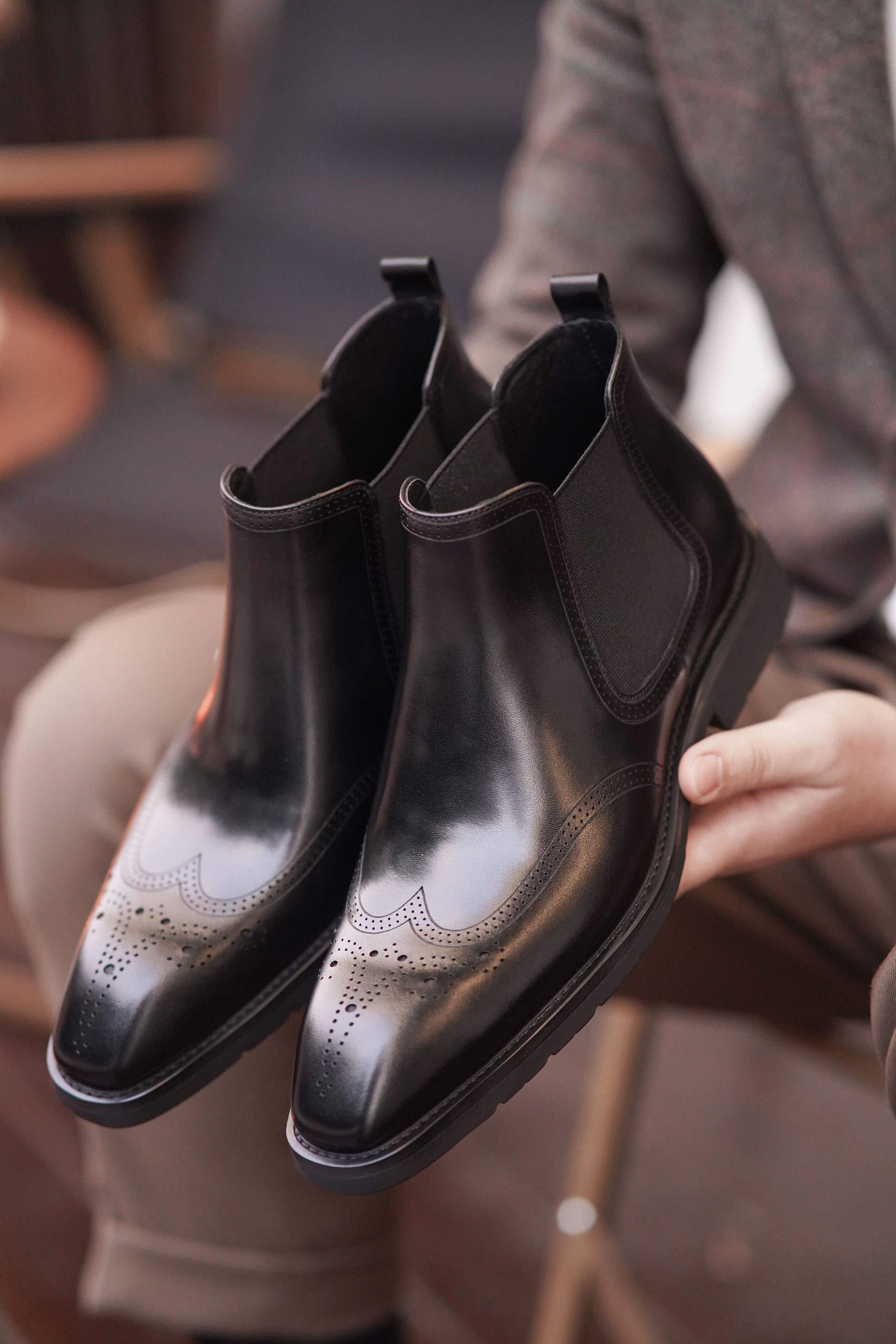 Men's Black Brogue Leather Boots with polished leather and intricate brogue detailing, featuring elastic side panels for comfort.