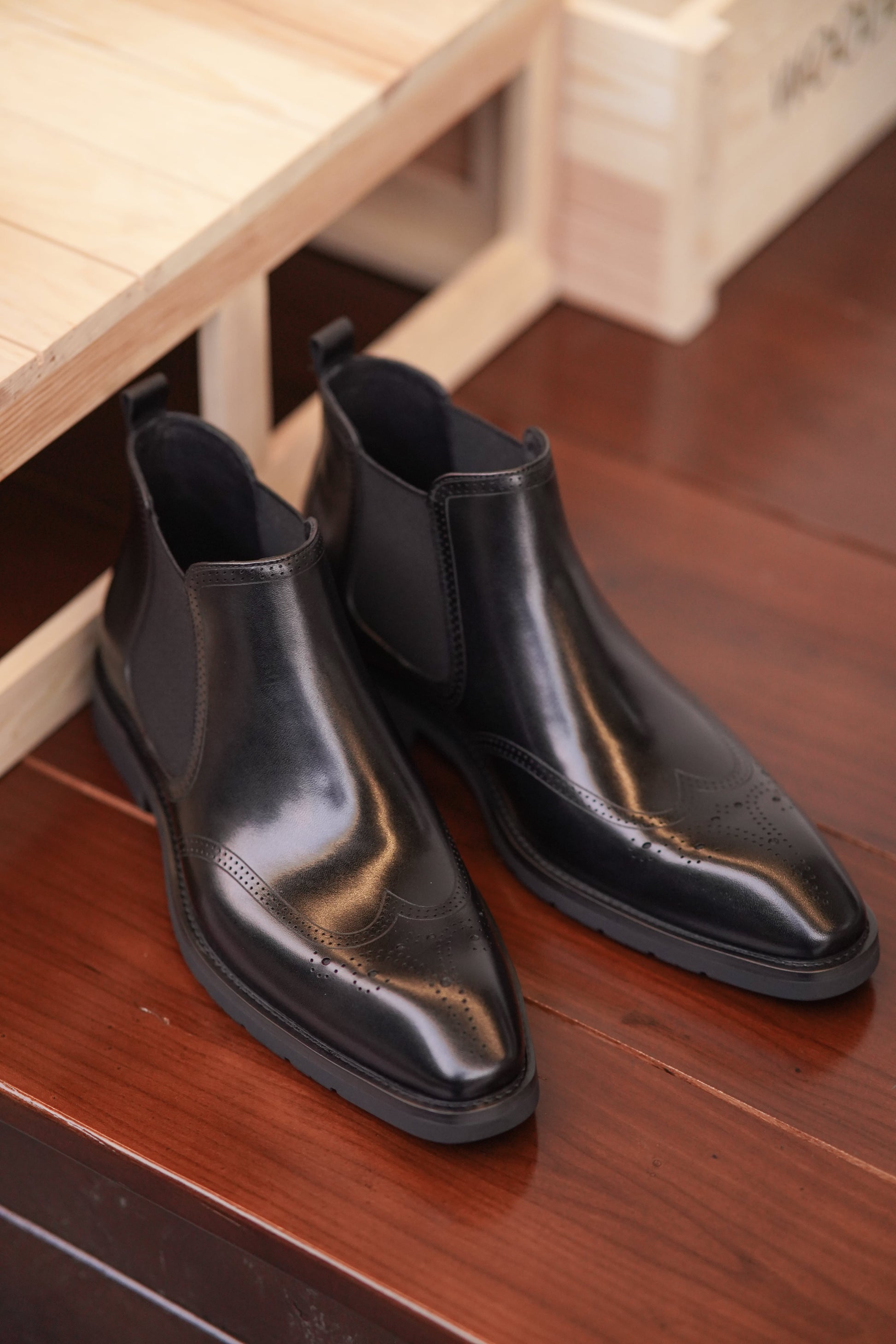 Men's Black Brogue Leather Boots with polished leather and intricate brogue detailing, featuring elastic side panels for comfort.