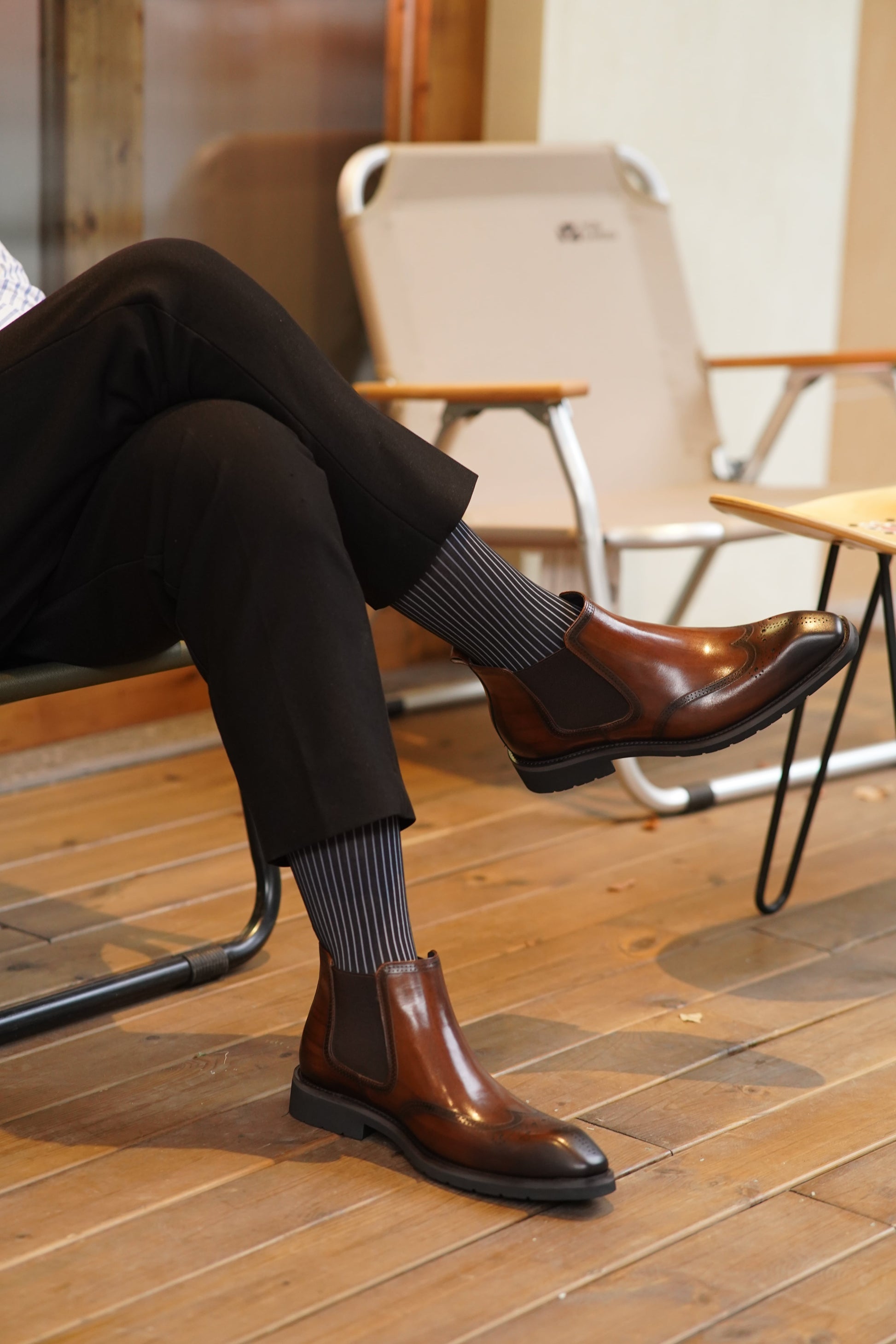 Cognac Brogue Spectator Chelsea Boots in polished brown leather with intricate brogue detailing for a refined look.