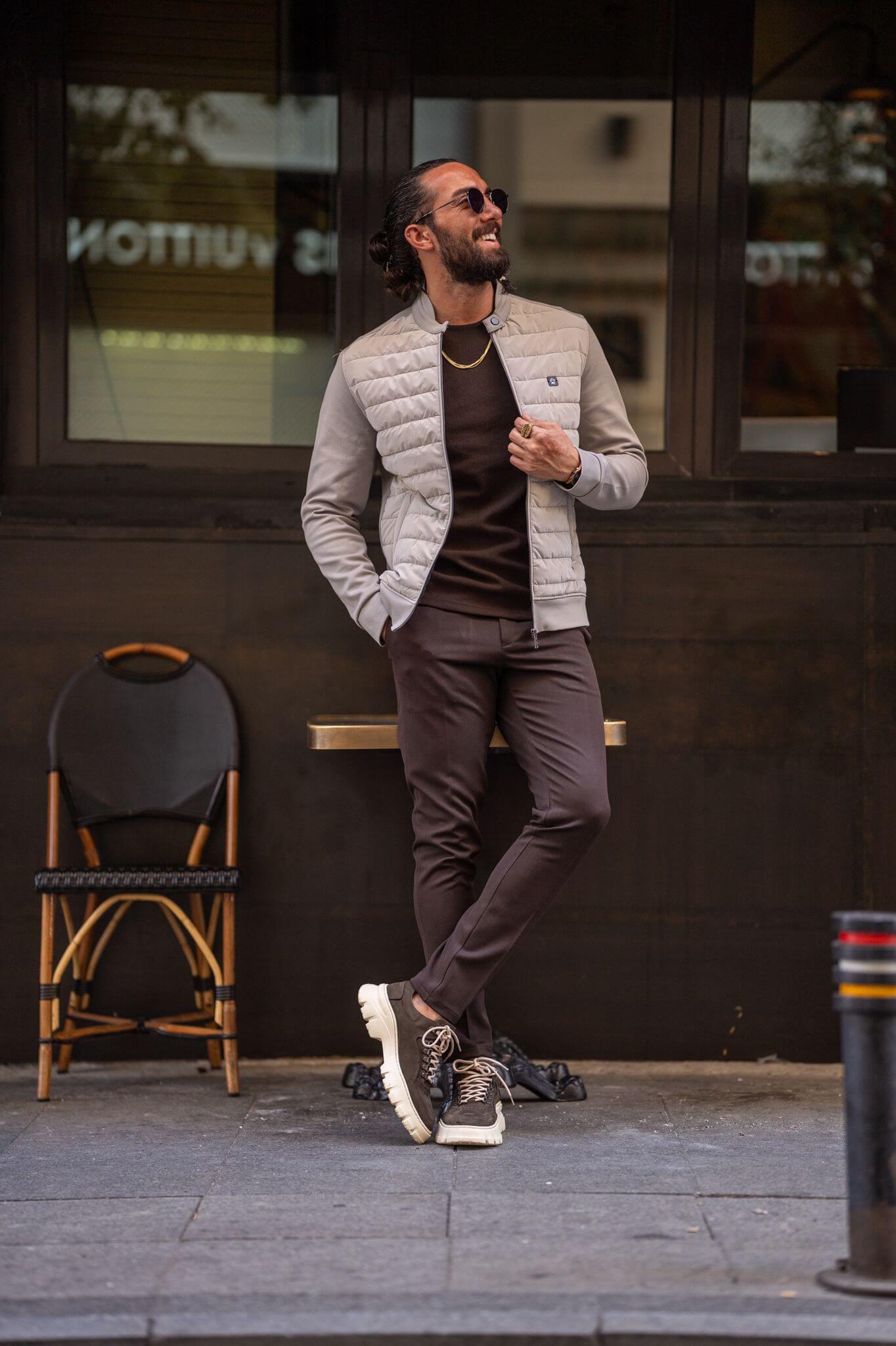 The epitome of sartorial charm, our male model presents a striking image in a beige coat.