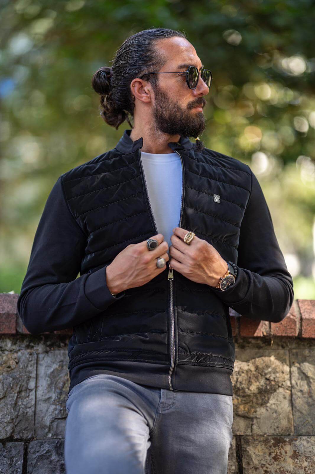 Male model donning a stylish black coat, embodying modern fashion elegance.