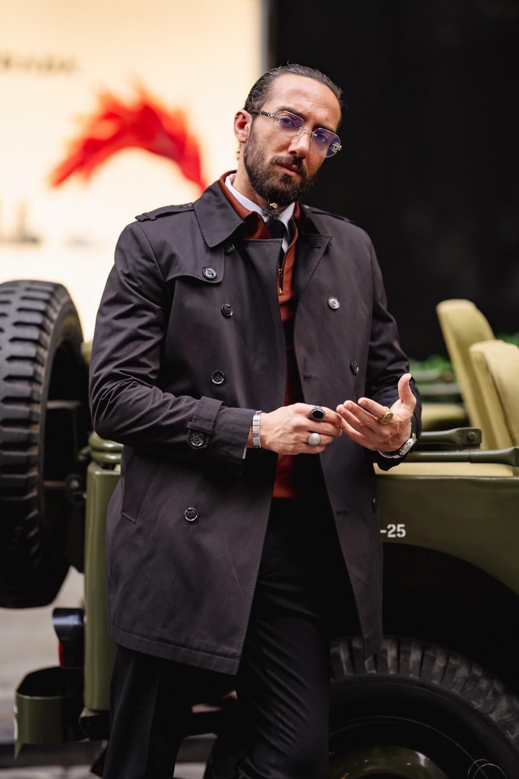 A Classic Black Trench Coat on display.