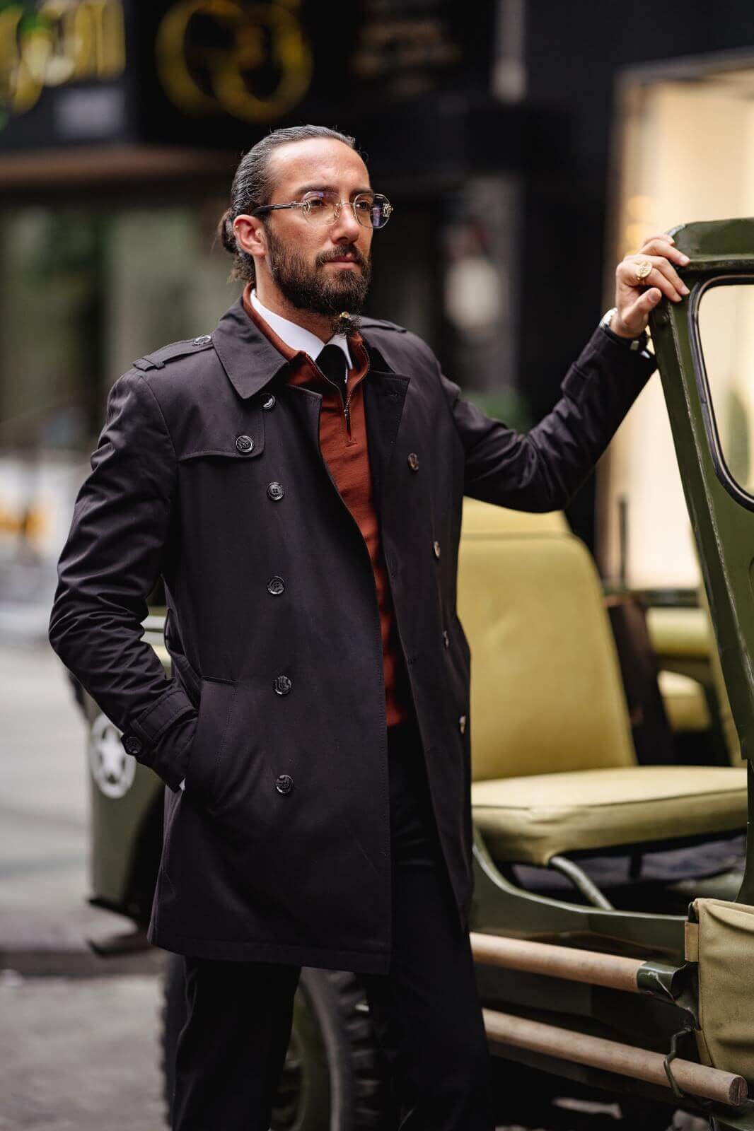 A Classic Black Trench Coat on display.