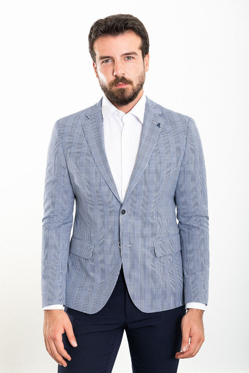 Model wearing a blue checkered blazer from HolloMen, showcasing modern sophistication and timeless elegance.