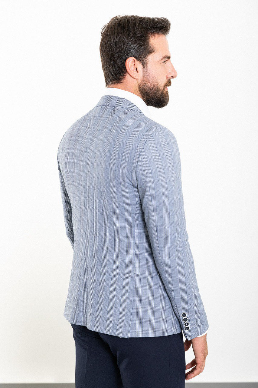 Model wearing a blue checkered blazer from HolloMen, showcasing modern sophistication and timeless elegance.