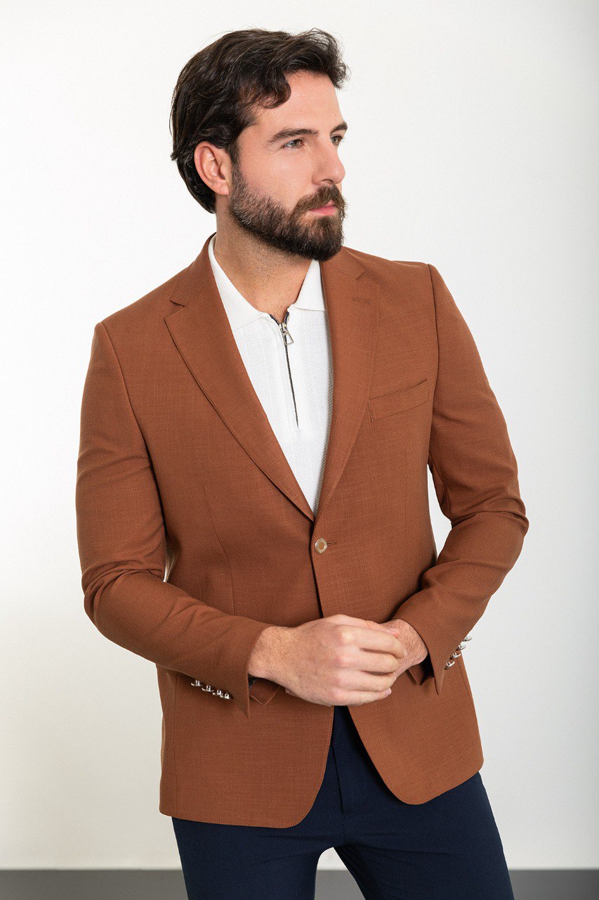 Model showcasing a stylish brown blazer from HolloMen, perfect for adding a touch of elegance to both formal and casual outfits.