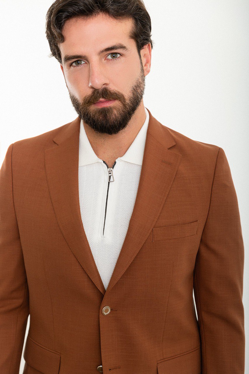 Model showcasing a stylish brown blazer from HolloMen, perfect for adding a touch of elegance to both formal and casual outfits.