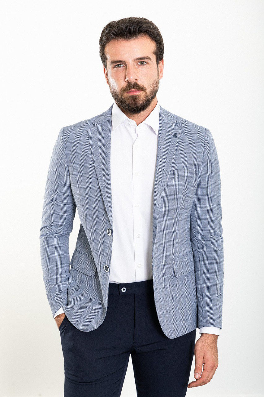 Model wearing a blue checkered blazer from HolloMen, showcasing modern sophistication and timeless elegance.