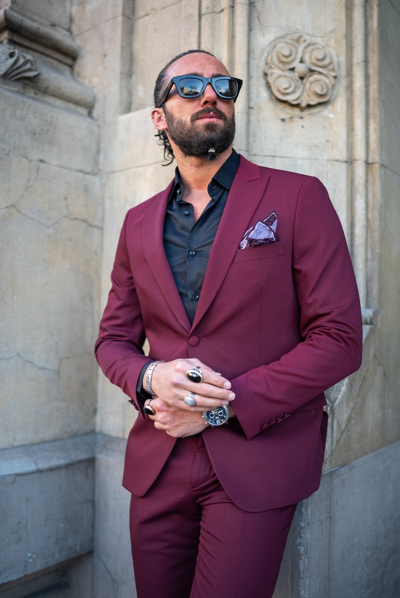 A Burgundy Brilliance Tuxedo Suit worn by a model