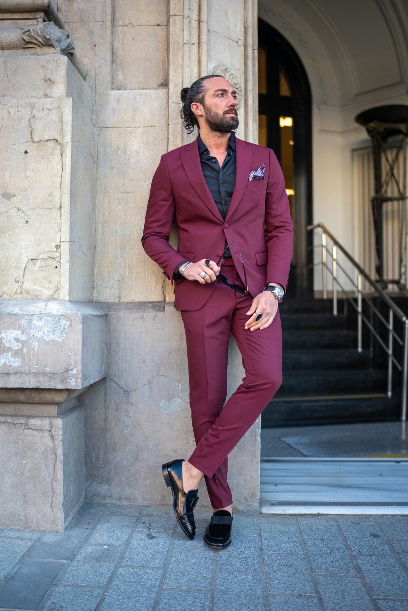 A Burgundy Brilliance Tuxedo Suit worn by a model