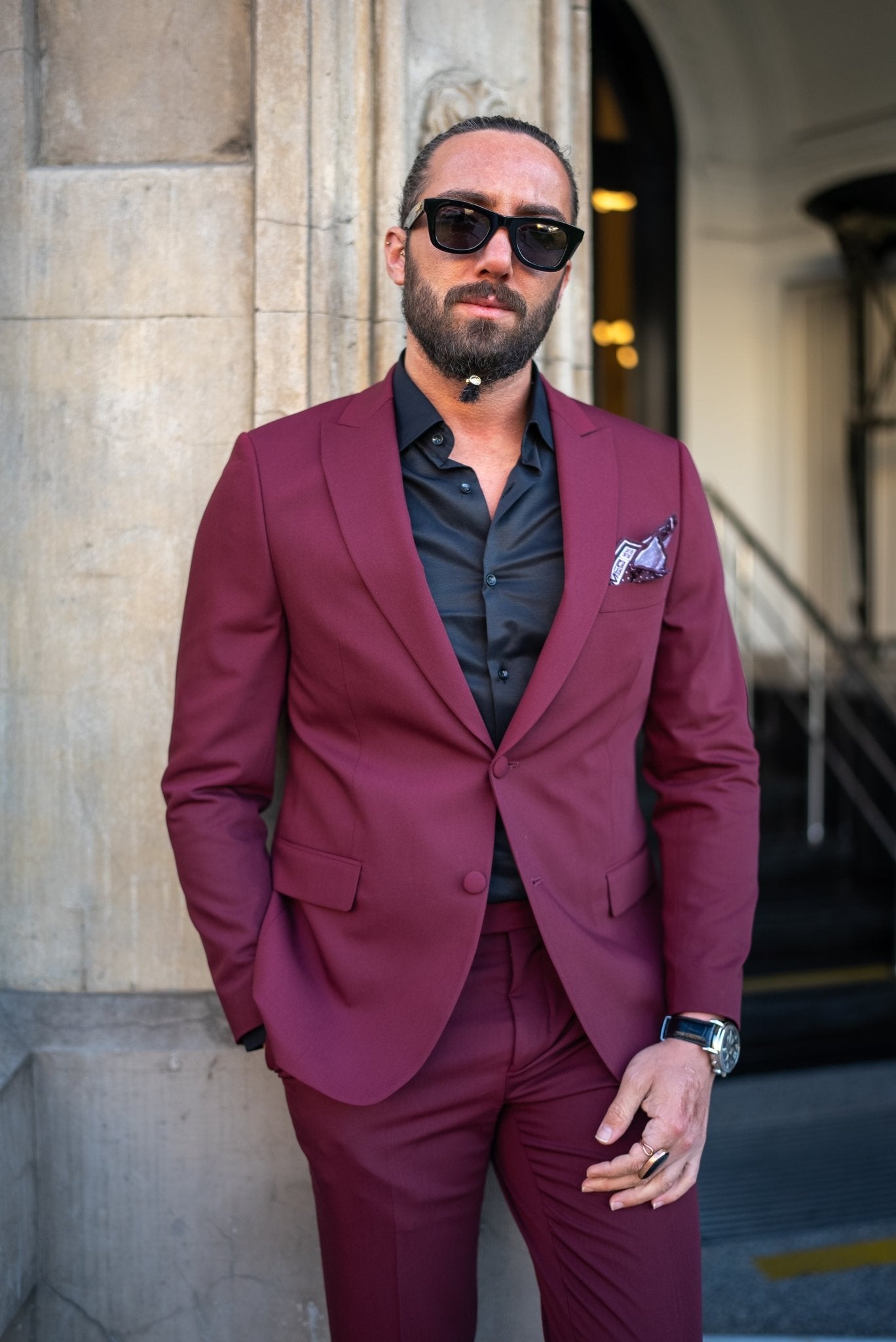 A Burgundy Brilliance Tuxedo Suit worn by a model