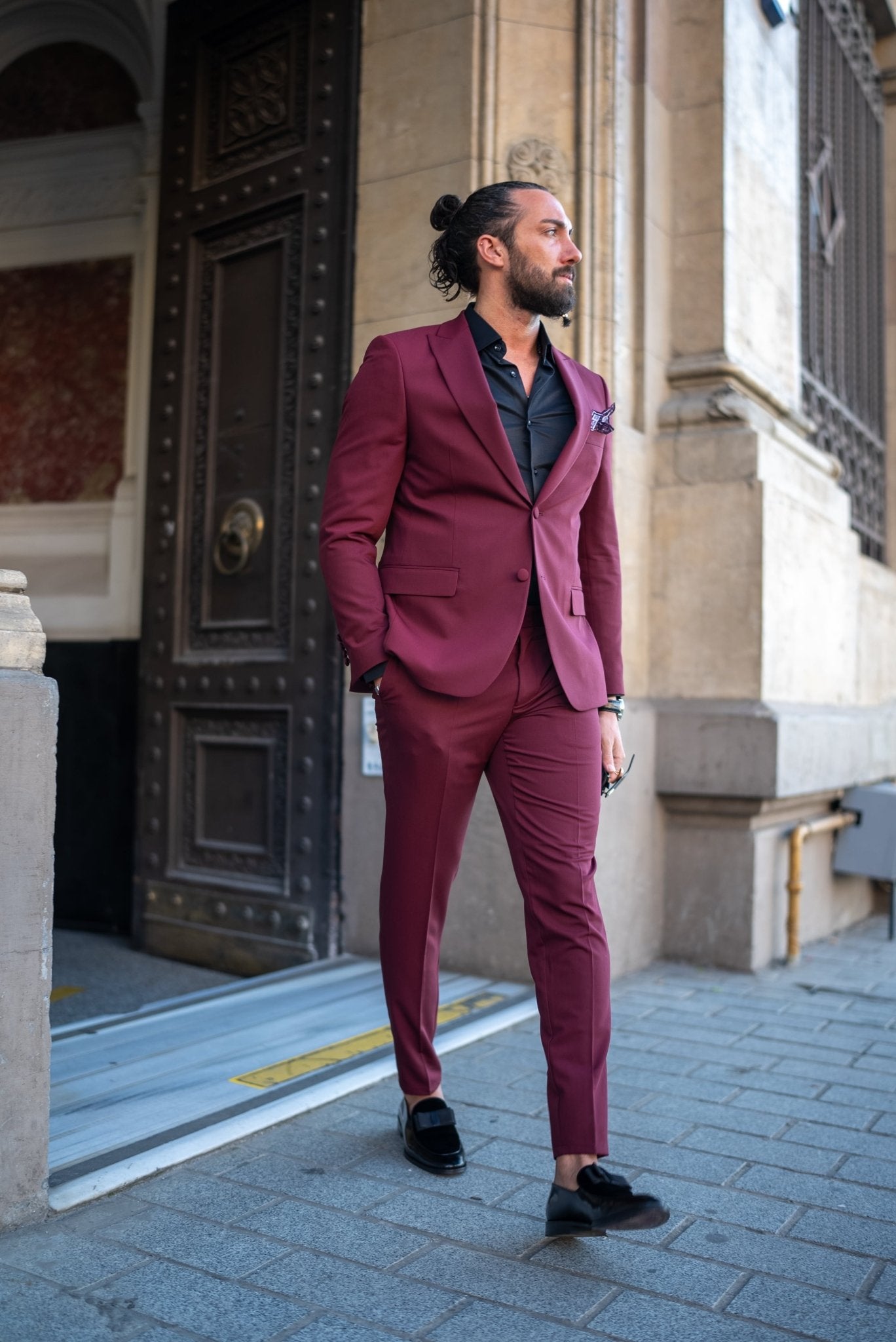 A Burgundy Brilliance Tuxedo Suit worn by a model