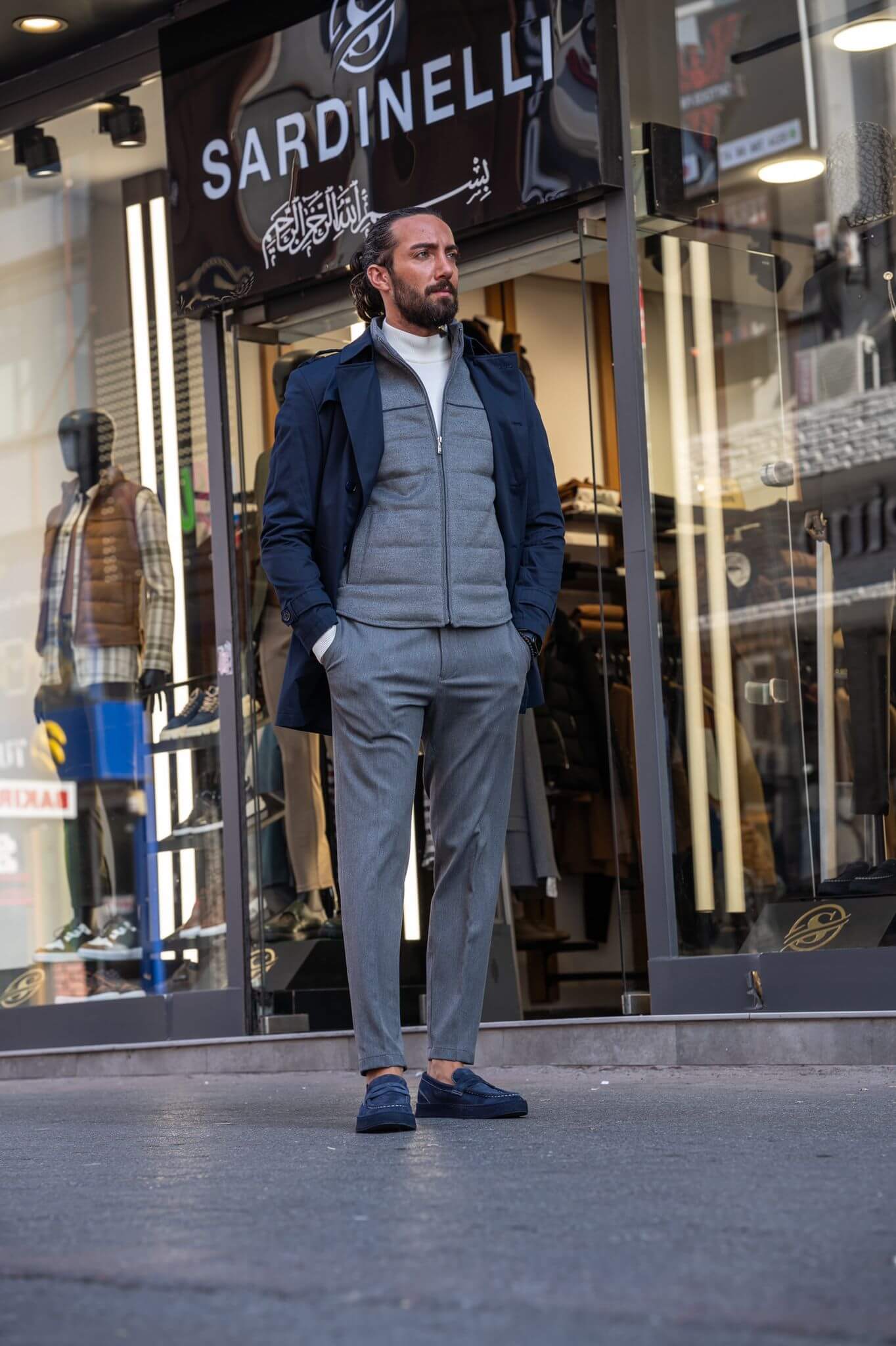 Chic and suave: our male model effortlessly rocks a navy blue trench coat.