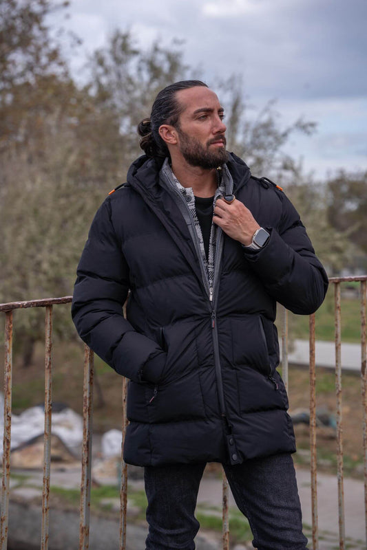 Striking male model confidently displays the sleek and stylish black puffer jacket.