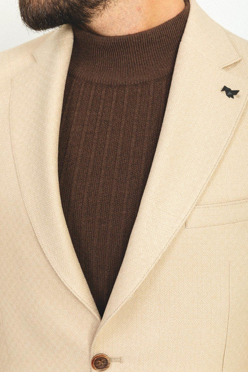 Close-up of the Eiffel Beige Jacket, focusing on the jacket's pointed collar, button details, and the luxurious fabric pattern.