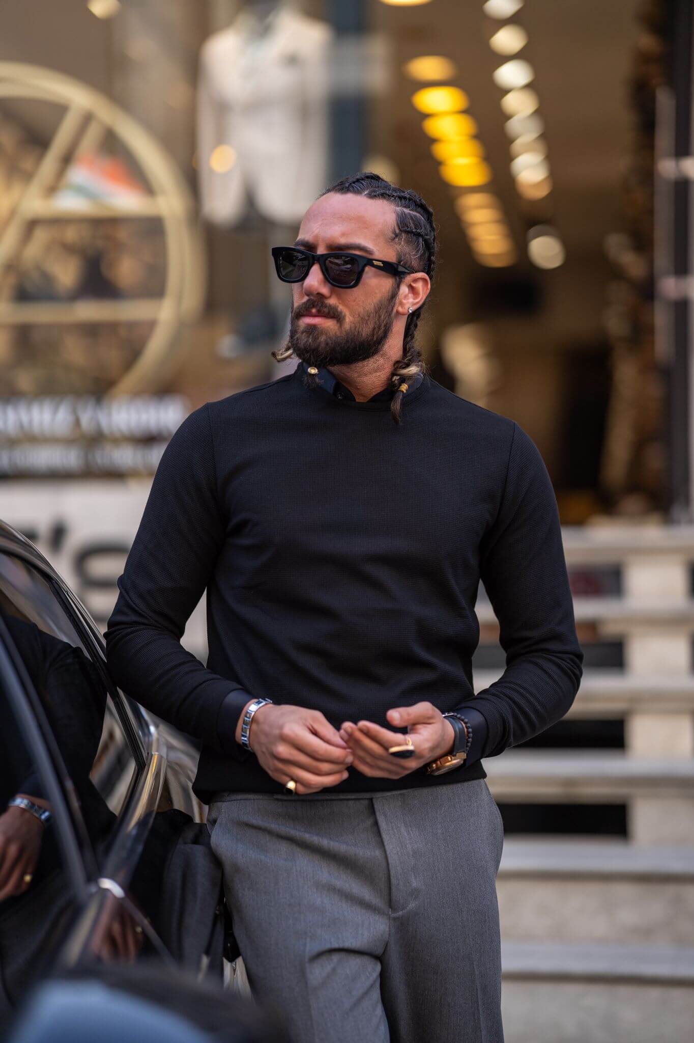 Casually chic: Our male model effortlessly rocks a black crewneck, epitomizing laid-back elegance.