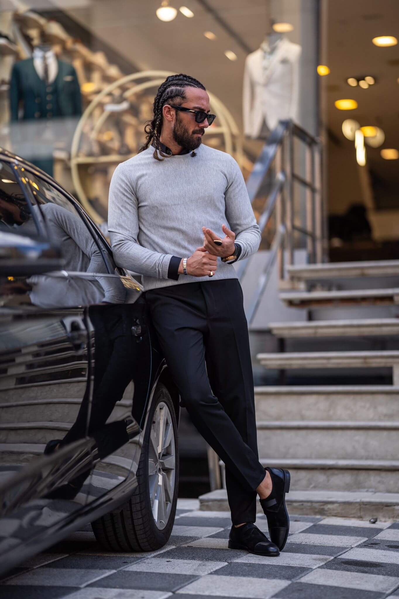 A stylish male model confidently displays our classic gray crewneck, showcasing its timeless appeal.