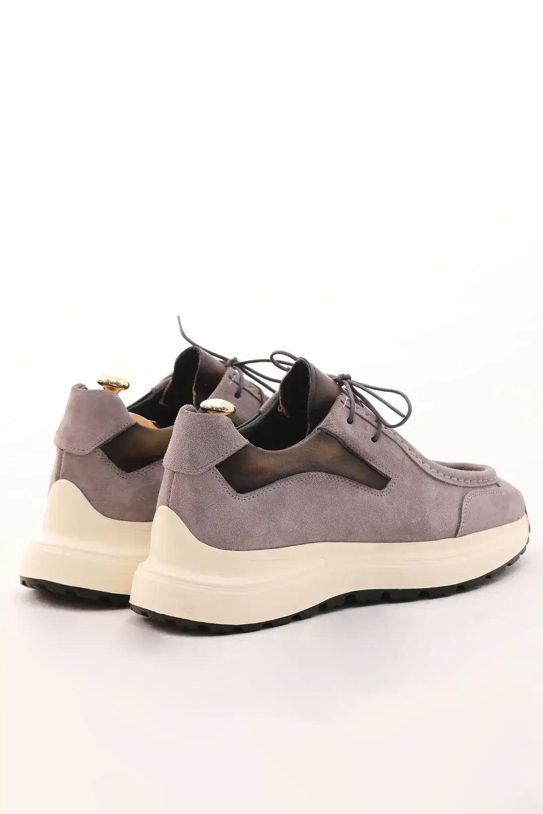 Light taupe suede casual sneaker with cushioned sole and leather accents.