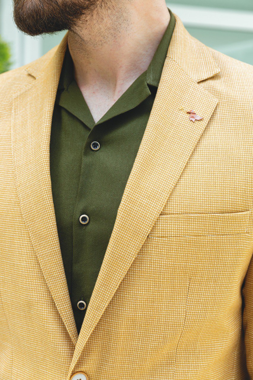 Close-up of a yellow textured blazer from HolloMen, showcasing modern elegance and bold style.