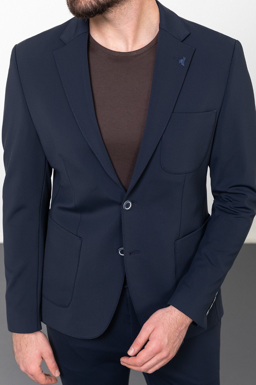 Man wearing a navy blue casual suit, blending modern style with comfort for effortless sophistication.