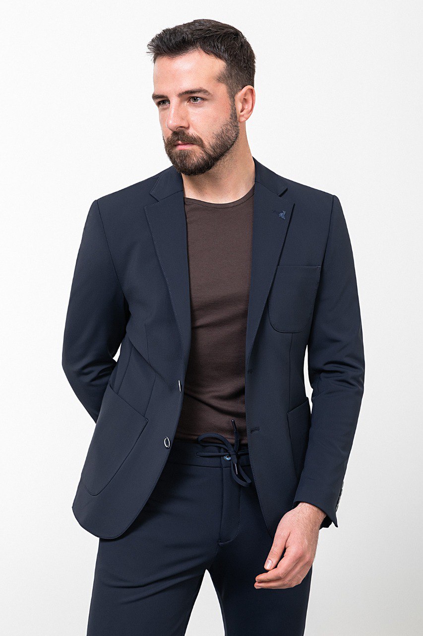 Man wearing a navy blue casual suit, blending modern style with comfort for effortless sophistication.