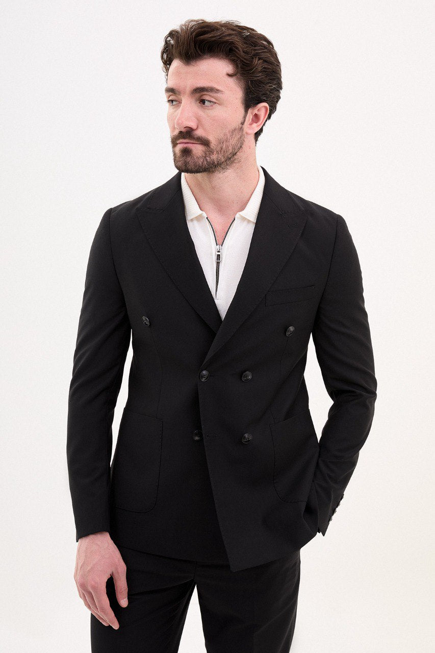 Model wearing a double-breasted black suit from HolloMen’s Spring Summer Collection, showcasing sleek and sophisticated tailoring.