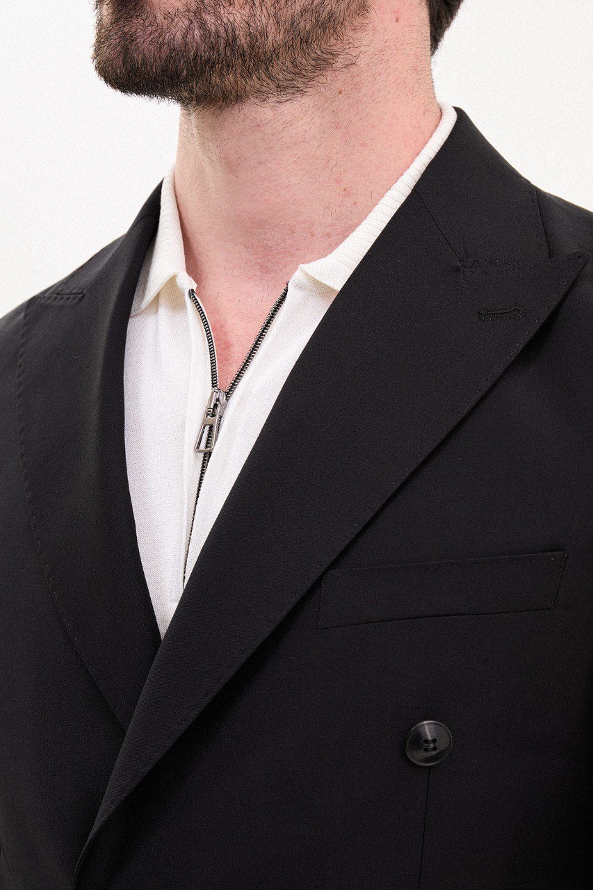 Model wearing a double-breasted black suit from HolloMen’s Spring Summer Collection, showcasing sleek and sophisticated tailoring.