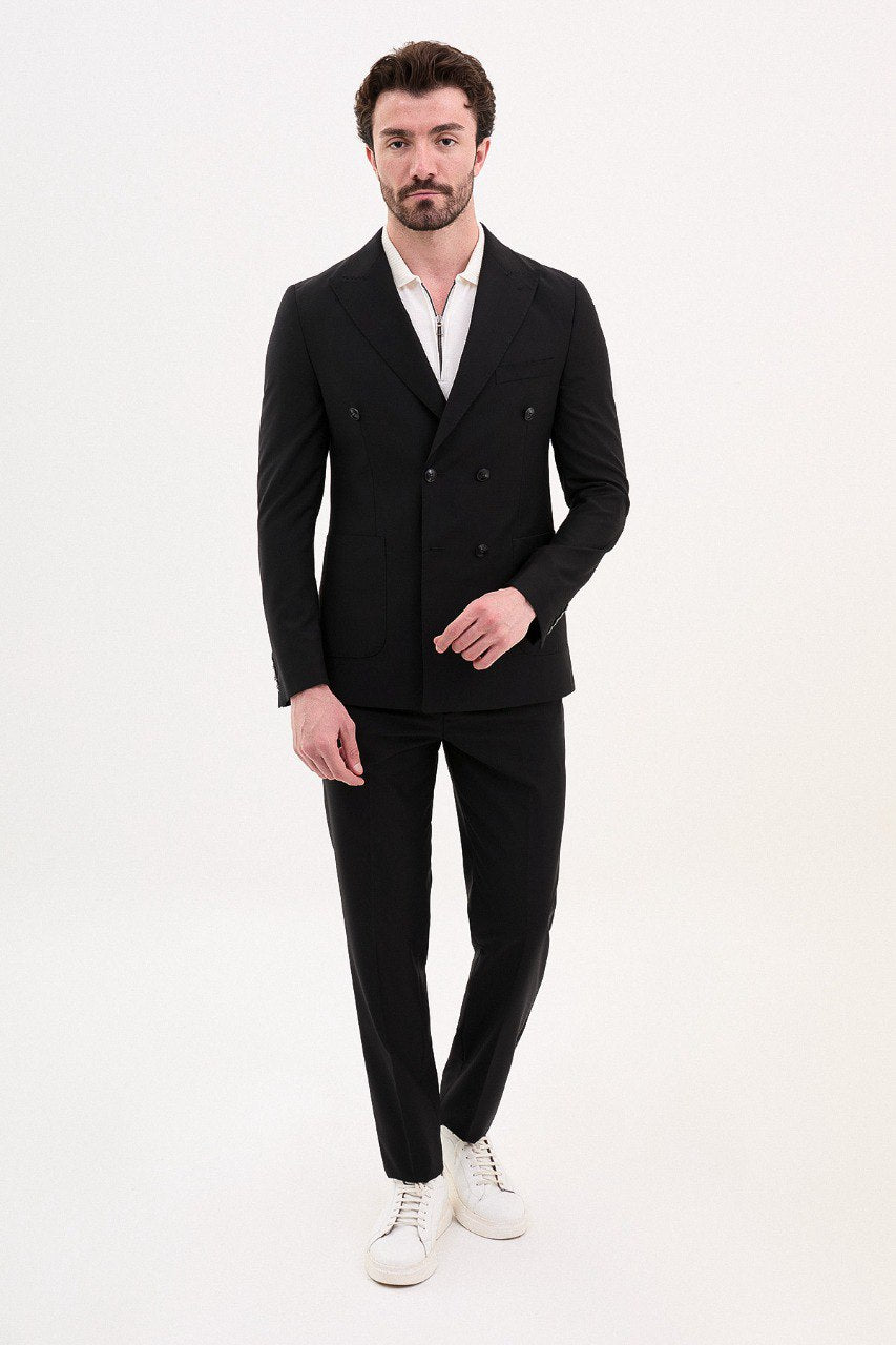 Model wearing a double-breasted black suit from HolloMen’s Spring Summer Collection, showcasing sleek and sophisticated tailoring.