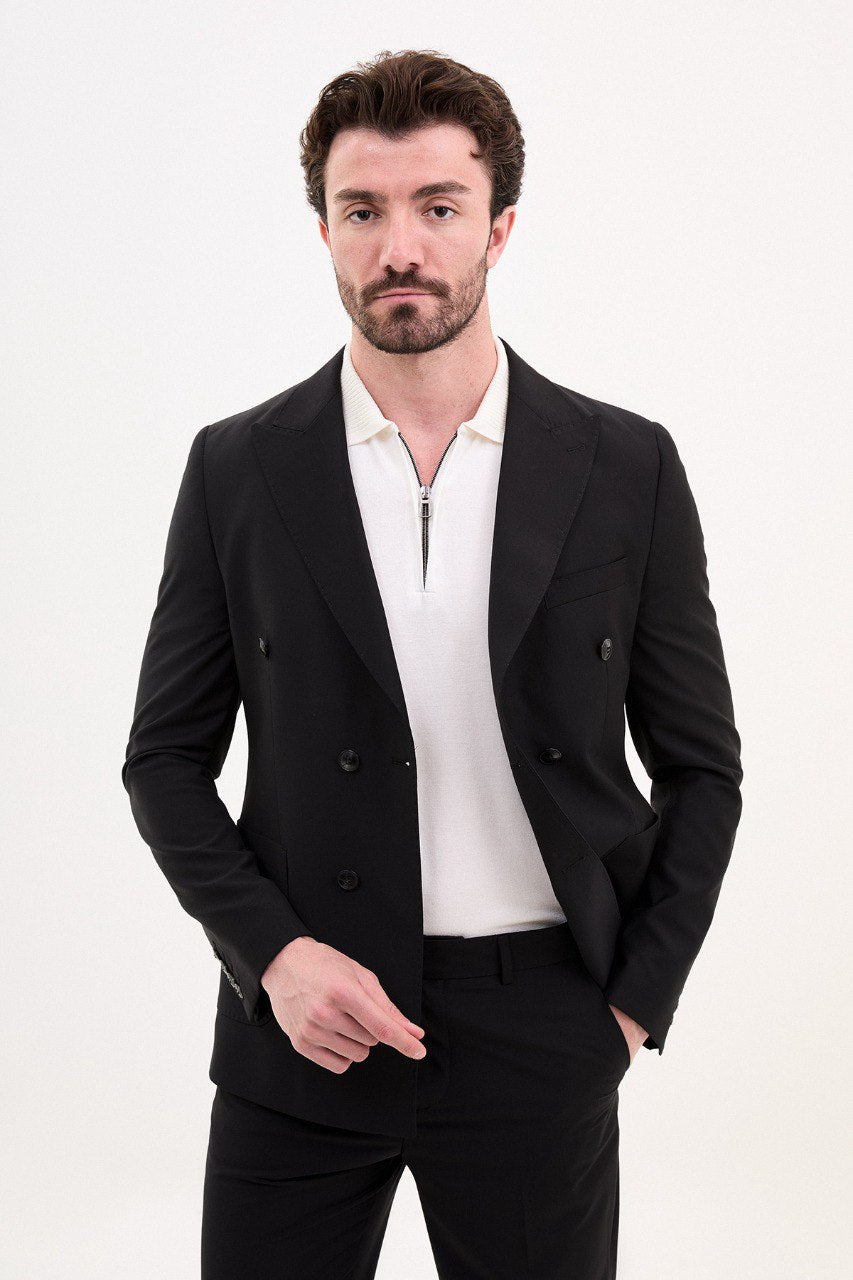 Model wearing a double-breasted black suit from HolloMen’s Spring Summer Collection, showcasing sleek and sophisticated tailoring.