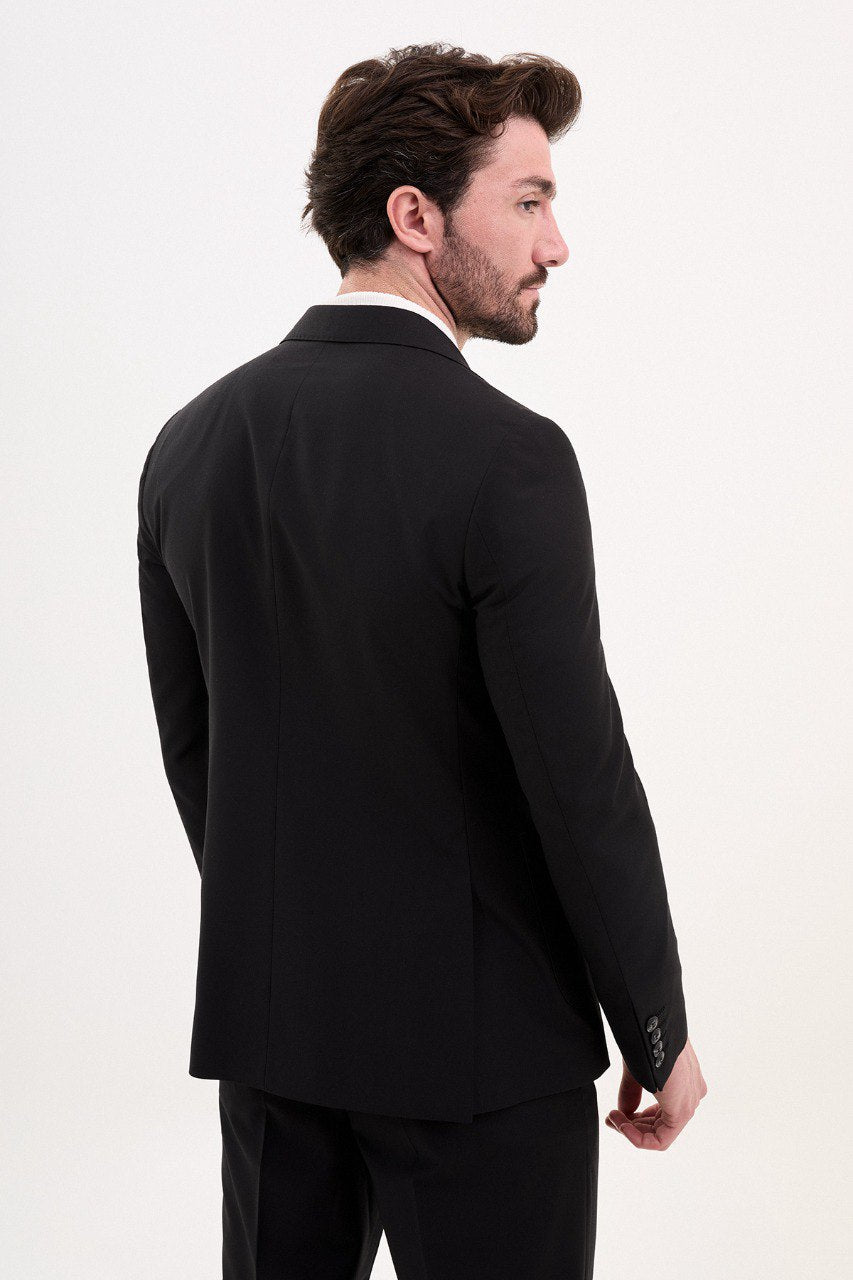 Model wearing a double-breasted black suit from HolloMen’s Spring Summer Collection, showcasing sleek and sophisticated tailoring.