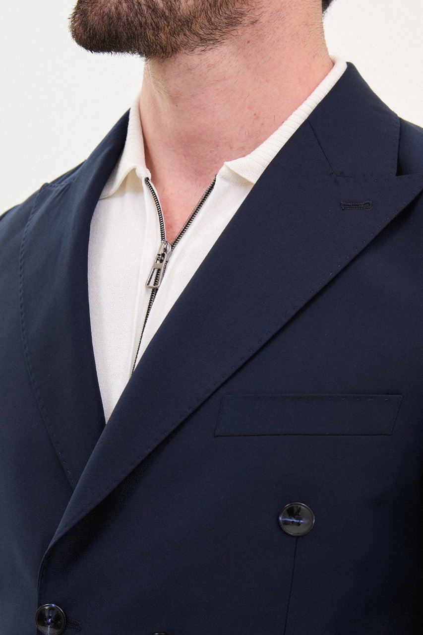 Model wearing a double-breasted navy blue suit from HolloMen’s Spring Summer Collection, showcasing refined tailoring and timeless elegance.