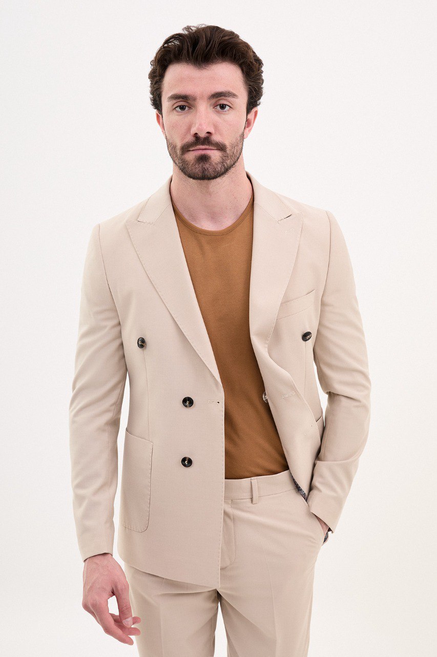 Man wearing a double-breasted beige suit with a casual brown shirt from HolloMen’s Spring Summer Collection.