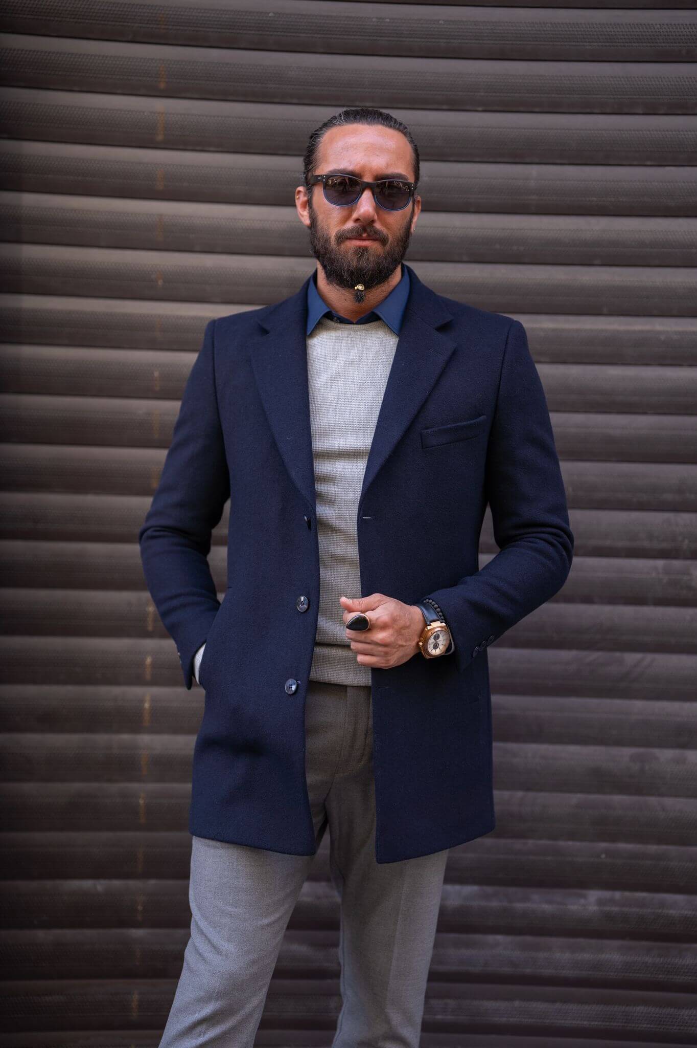 Confident male model exudes sophistication in our impeccably tailored navy blue coat.