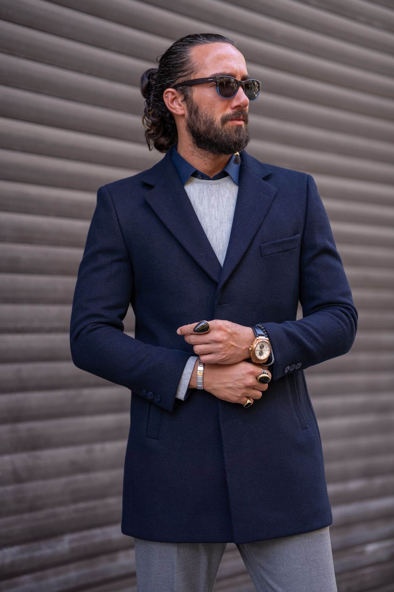 Confident male model exudes sophistication in our impeccably tailored navy blue coat