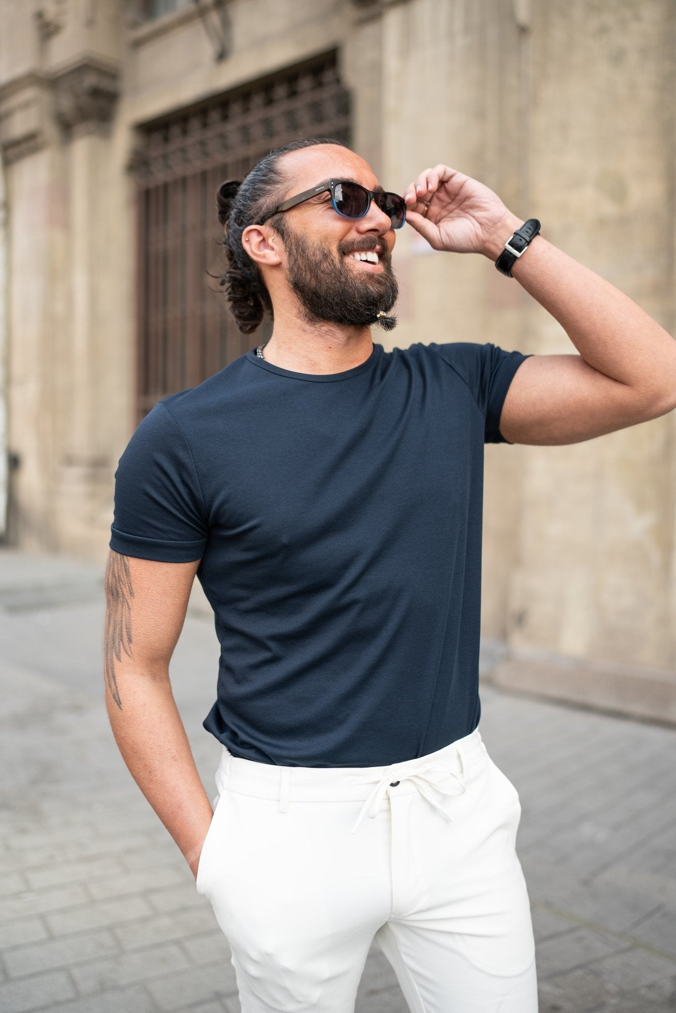 A Navy blue T-shirt worn by a model