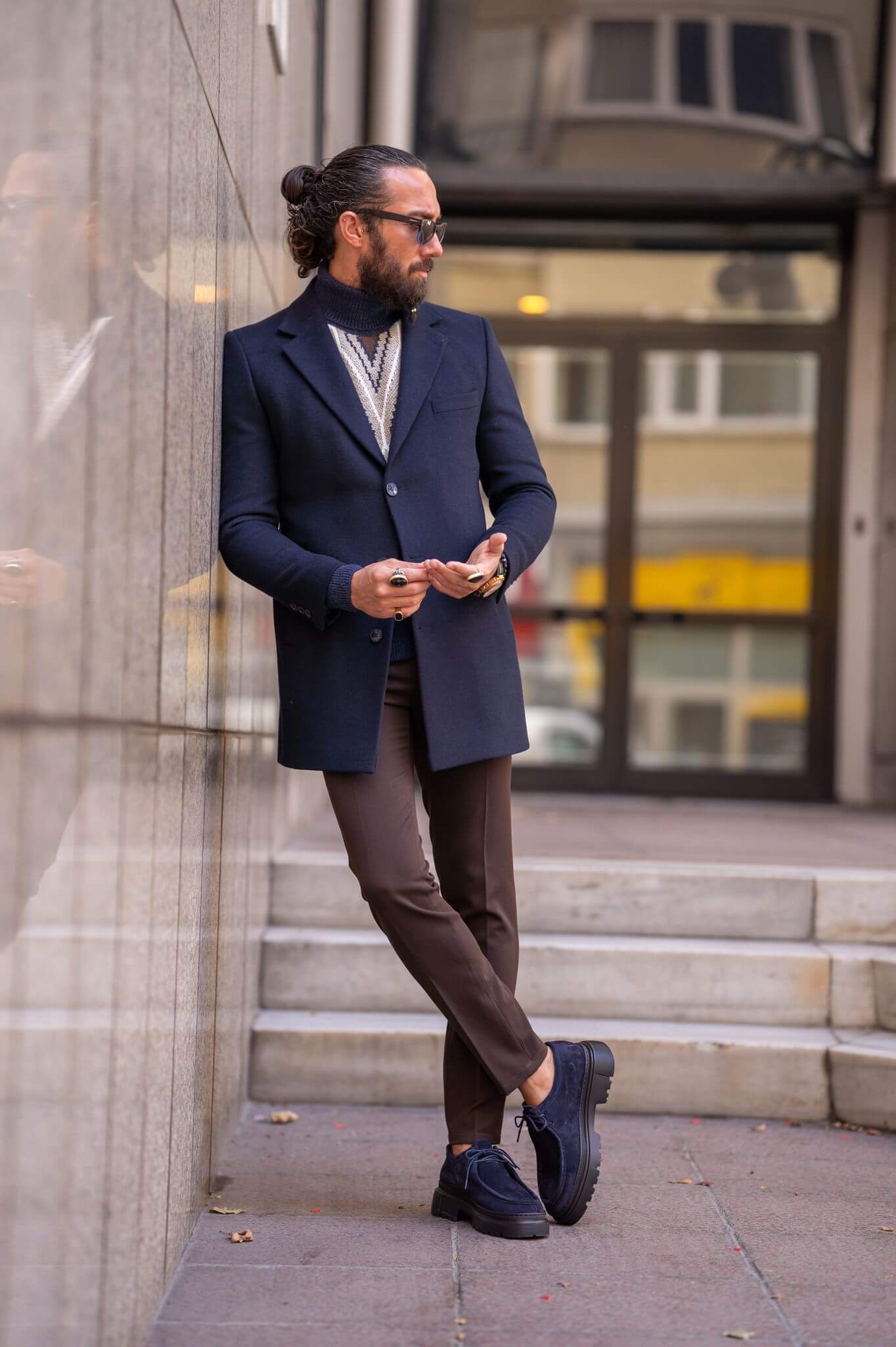 Striking male model confidently presents our latest fashion statement: the Navy Blue Coat,