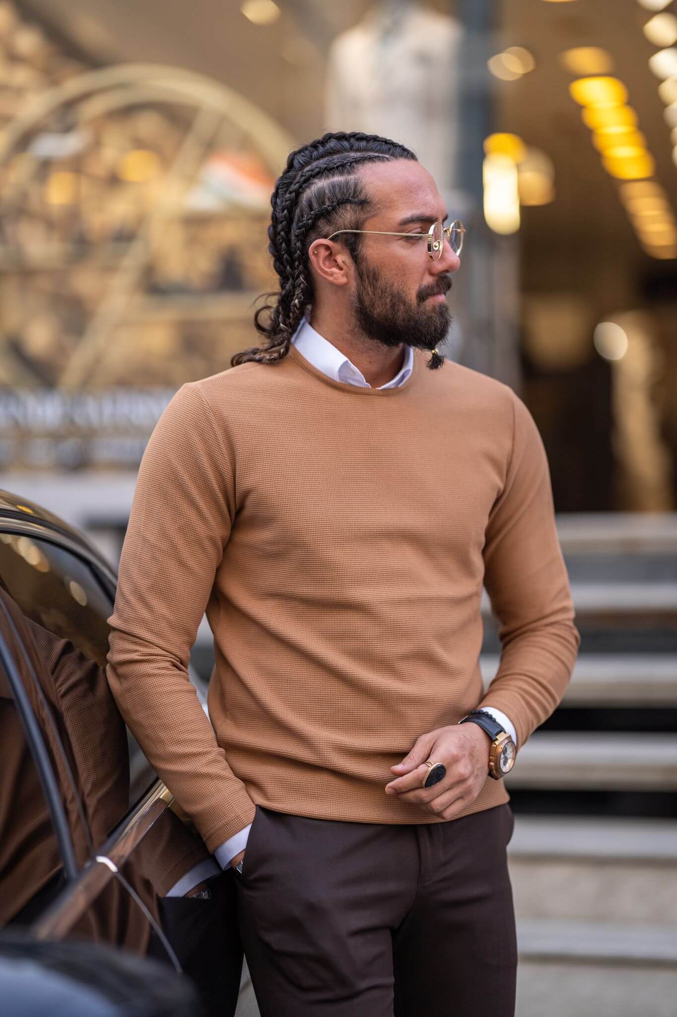 Experience the cozy allure of our camel crewneck on a stylish male model, embodying laid-back luxury.