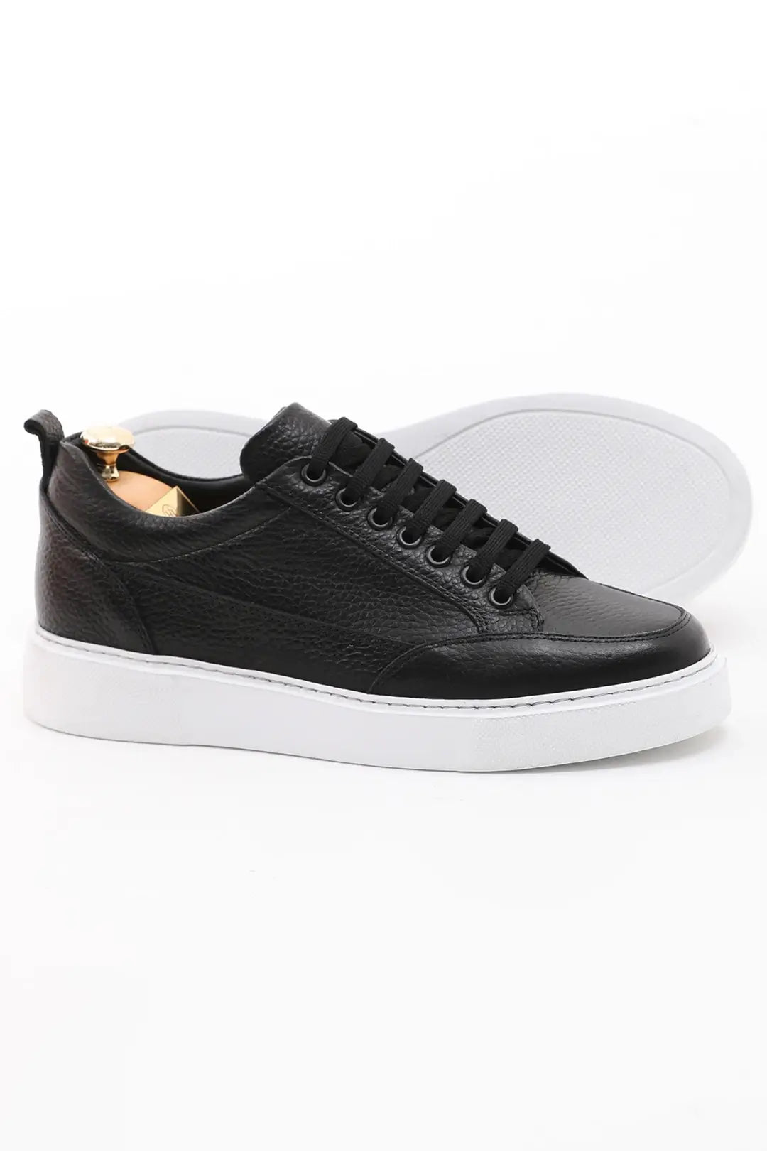 Black leather sneakers with white EVA sole. 