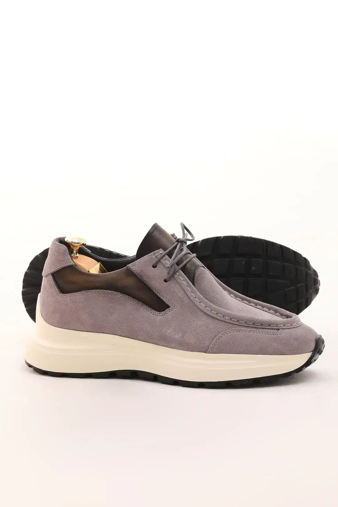 Light taupe suede casual sneaker with cushioned sole and leather accents.