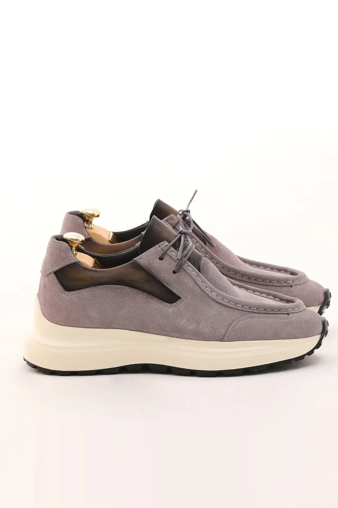 Light taupe suede casual sneaker with cushioned sole and leather accents.