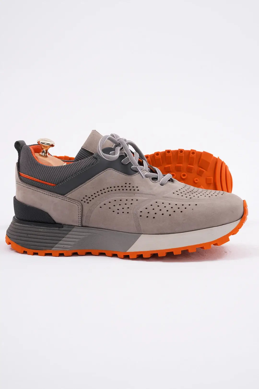 TrailBlaze Gray Leather Performance Sneakers with orange sole and perforated design.